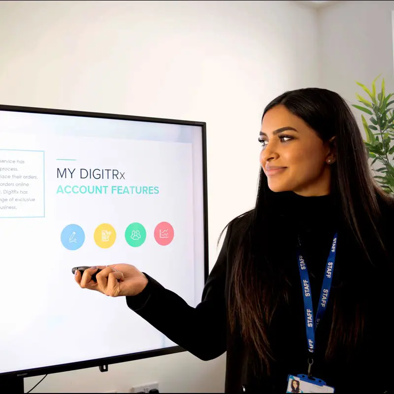 Healthcare Professional providing a training presentation on a large screen